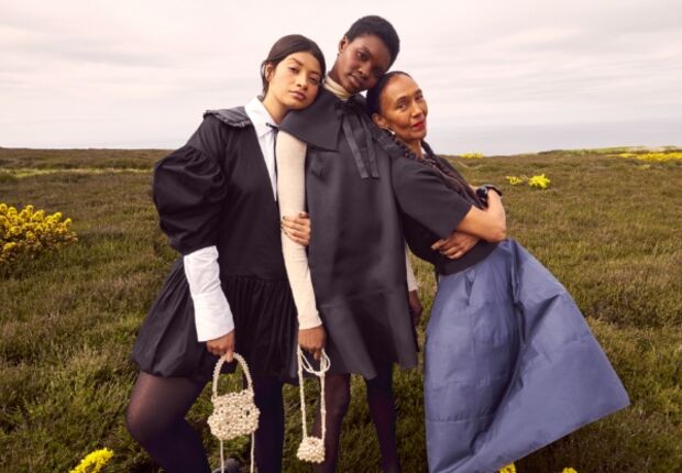 Three women wearing high-fashion winter clothes.